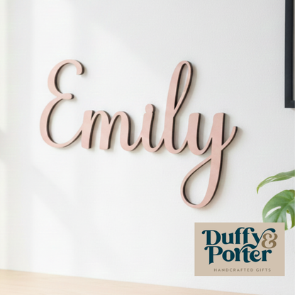 Wooden name sign spelling 'Emily' on a white wall with Duffy & Porter branding.