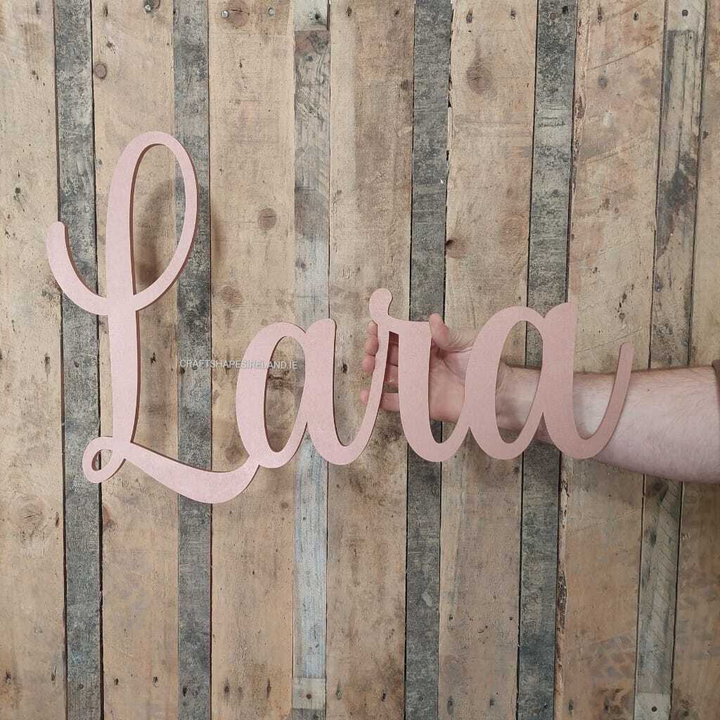 Wooden name 'Lara' sign held against a wooden background