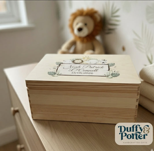 Wooden keepsake box with name and date on a shelf, with a teddy bear in the background.