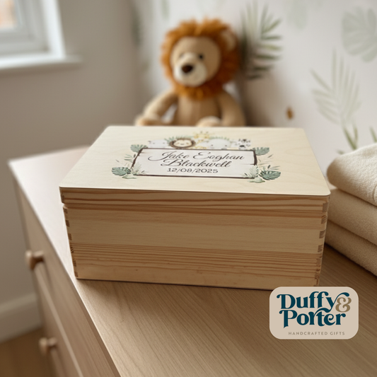 Wooden keepsake box with text on a surface, featuring a teddy bear and plant decor in the background.